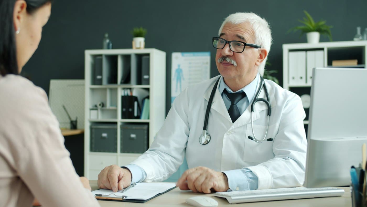 A provider talking with a patient across a desk