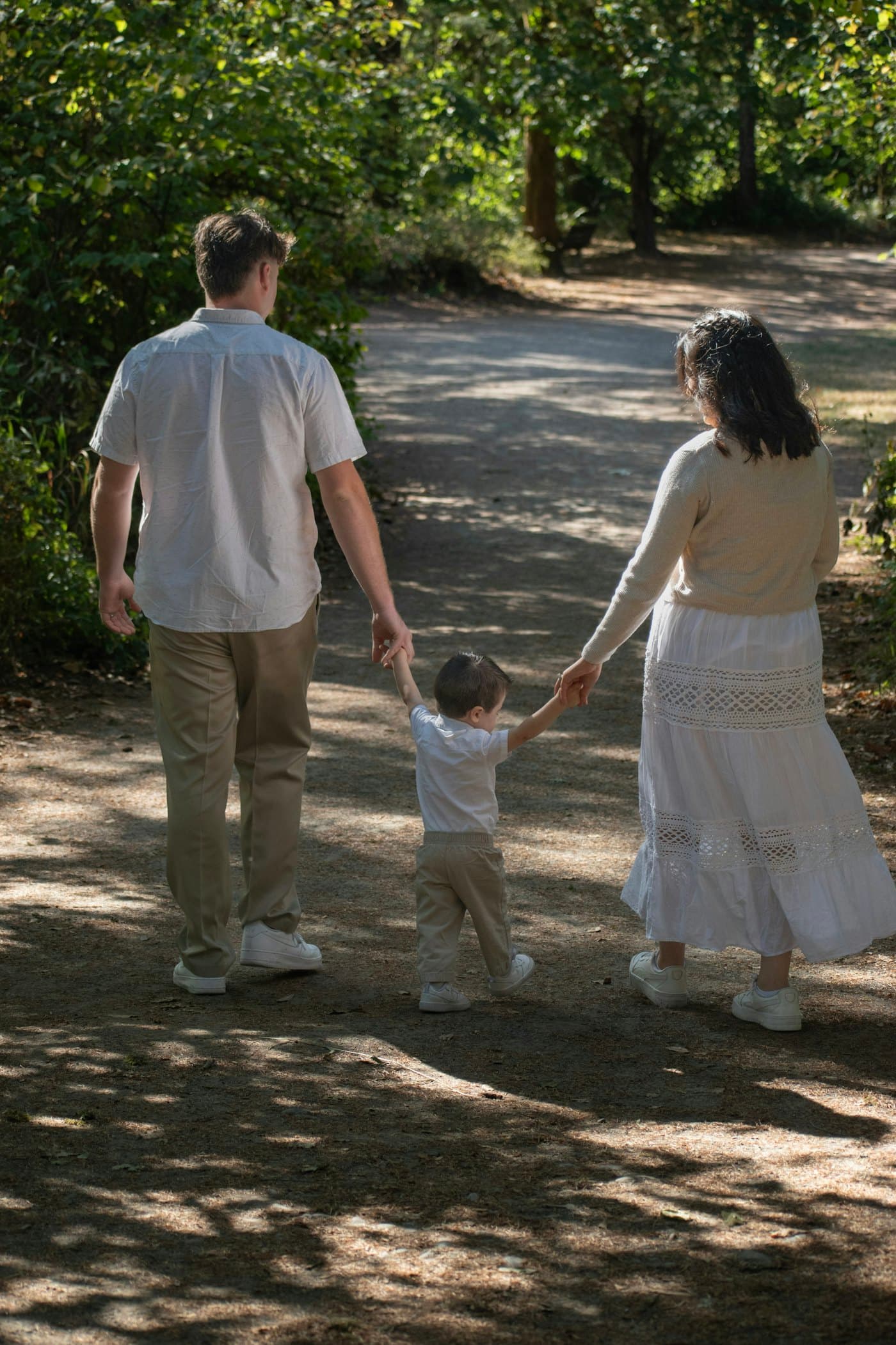 A family walking hand in hand along a path