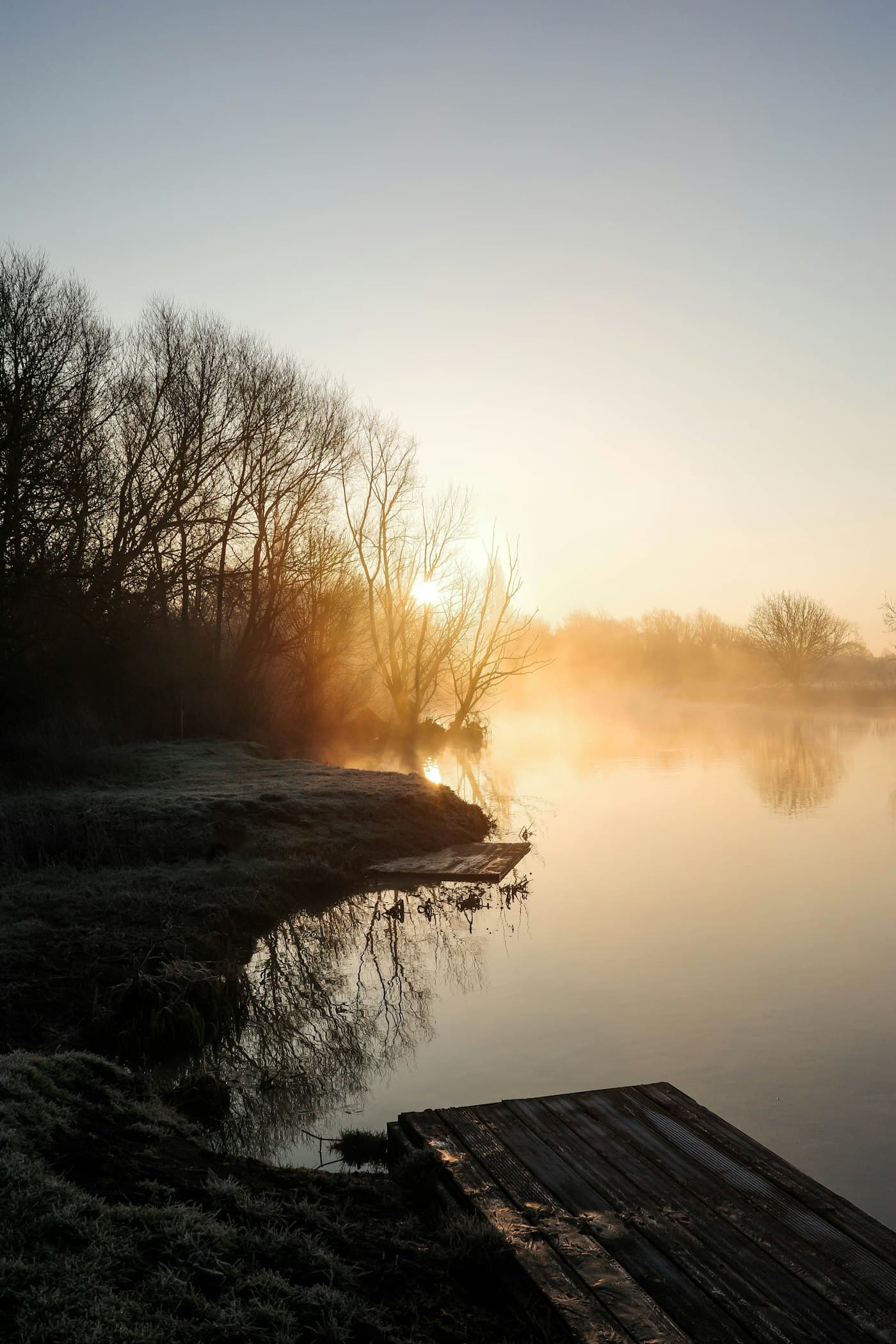 Mist over still water at sunrise